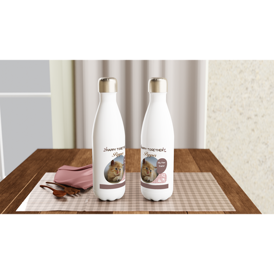 Two white bottles with cat illustrations on a wooden table.