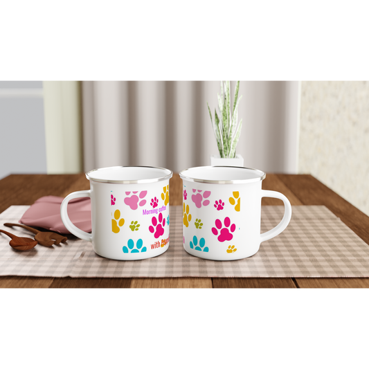 Two white mugs with colorful paw prints on a wooden table.