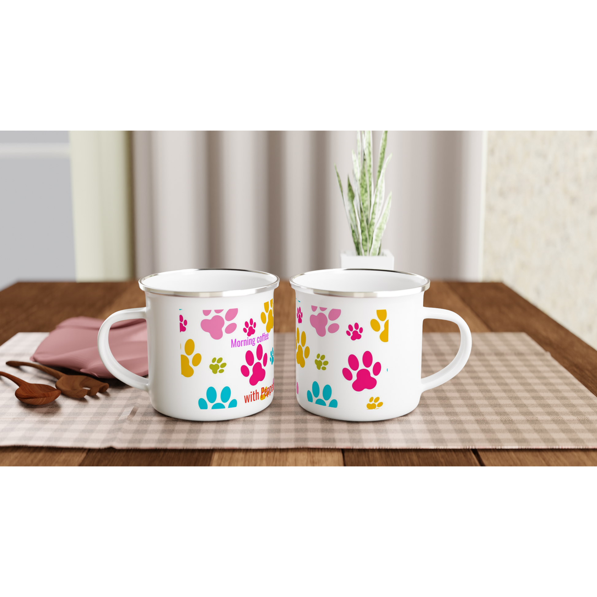 Two white mugs with colorful paw prints on a wooden table.